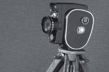 Old movie camera on a tripod - 474173382
