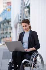 Disabled businesswoman in a wheelchair working outside