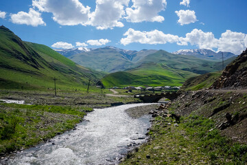 Fototapeta na wymiar Mountain river in the village of Richa in sunny weather