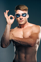 sports man with naked torso swimmer professional dark background