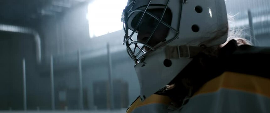 HANDHELD Portrait of the hockey goalie posing inside the indoor ice rink. Shot with 2x anamorphic lens