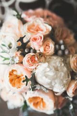 Beautiful toned picture with wedding rings against the background of a bouquet of flowers