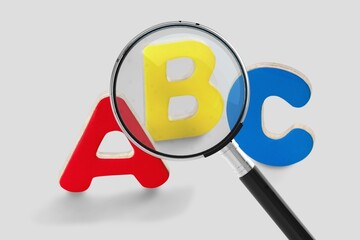 Magnifying glass on many English alphabet letters. Keyword searching.