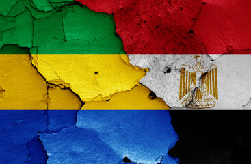 flags of Gabon and Egypt painted on cracked wall