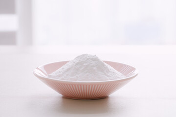 White powder in a pink bowl.