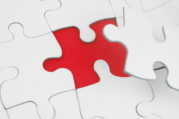 Fototapeta premium White jigsaw puzzles background, one piece missing and ready to connecting. Business strategy, teamwork, problem solving and complete mission concept. 