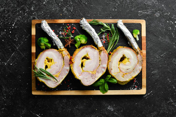 Pork loin on the bone baked with spices and seasonings. Top view. Rustic style.