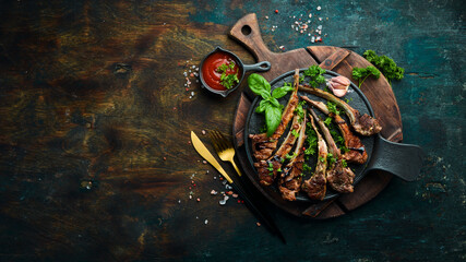 Roasted lamb chops on a dark creative restaurant background. Free copy space. © Yaruniv-Studio