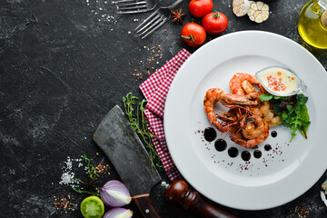 Grilled shrimps with sauce on a plate. Top view. Free copy space.