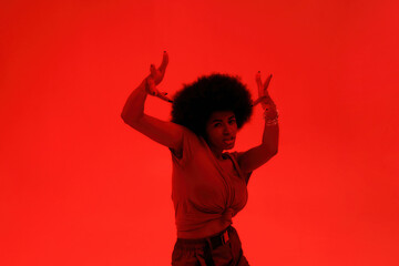 Young black brunette woman dancing hip hop dance