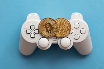 Crypto gaming concept. Video game controller with a bitcoin cryptocurrency coin © ink drop