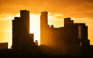 Fototapeta premium Sunrise in New York with dramatic sky and view to the tall skyscraper office buildings. Amazing color vibe. View to Astoria neighbourhood. Travel to America.