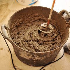 Bricklayer making cement mortar mix with industrial mixer 