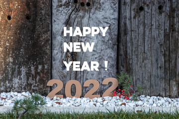 New Year's composition 2022 with wooden background logs