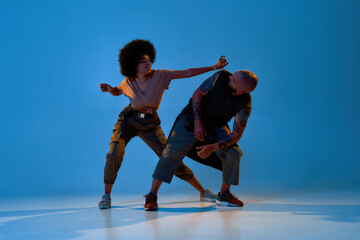 Young cool man and woman dancing hip hop dance