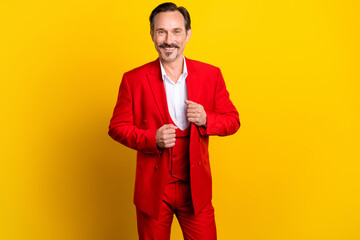 Photo of attractive well-dressed businessman in red vivid costume prepare for party isolated on yellow color background