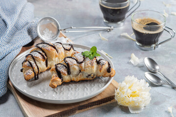Homemade croissant served with black coffee or americano. Delicious breakfast with fresh croissant and coffee.