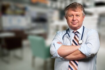 Smiling doctor wearing medical coat looking at camera.