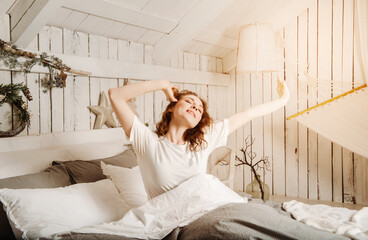 1 european young beautiful woman with red hair in bed smiling, bright room