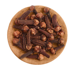 Dry spice cloves in wooden bowl isolated on white background with clipping path. Top view. Flat lay