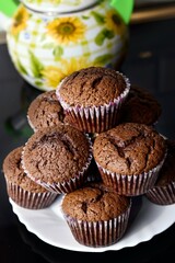 Homemade chocolate muffins on black background