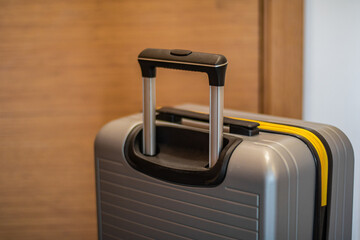 gray suitcases at the entrance of the hotel room's orange door, 