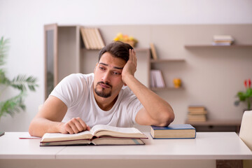 Young male student studying at home during pandemic