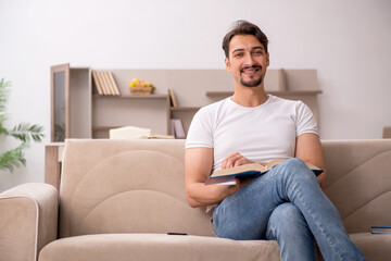 Fototapeta premium Young male student studying at home during pandemic