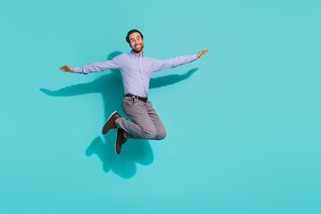 Fototapeta premium Photo of carefree inspired representative jump vacation concept wear purple shirt isolated turquoise color background