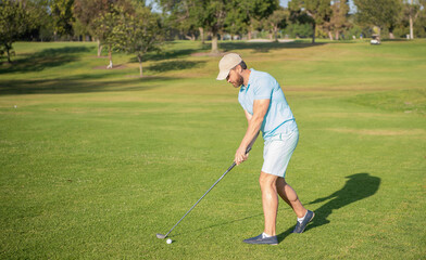 golfer full length in cap with golf club, summer