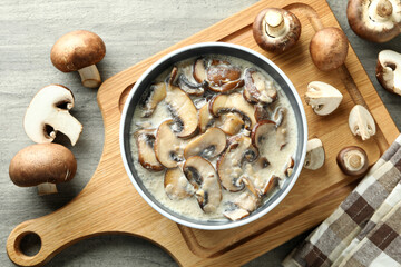 Concept of tasty food with mushroom sauce on gray wooden background