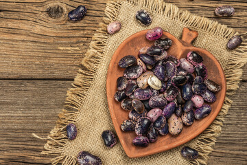Assorted multicolored beans in a ceramic bowl