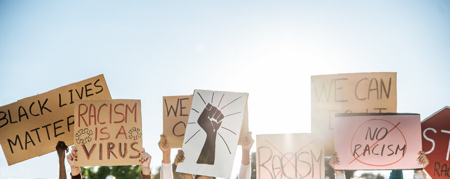 People standing with posters with inscription Black Lives Matter on meeting