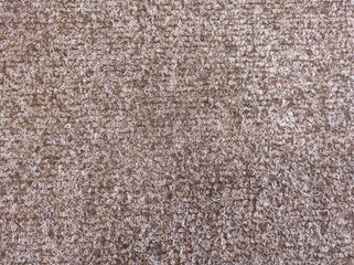 Close-up of brown carpet texture background indoors. Texture of brown carpet texture.