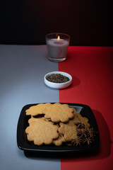 A pile of homemade gingerbread cookies on a plate against the festive background.