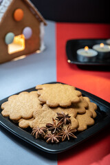A pile of homemade gingerbread cookies on a plate against the festive background.