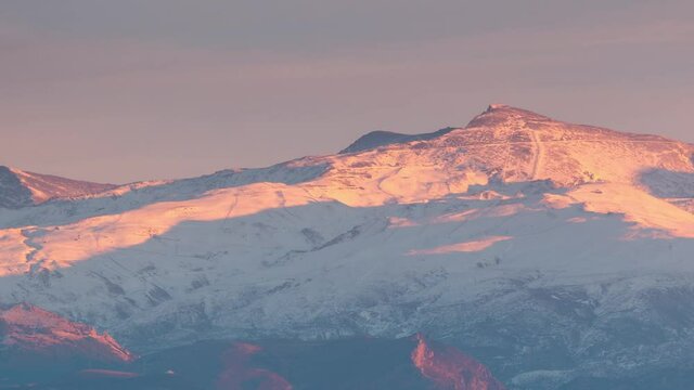 Sierra nevada Veleta Peak during sunset day to night time lapse of snowy mountain and ski resort