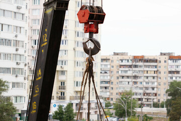 Crane hook. Tower Crane Hoist Rope against the blue sky and new building. Hawser of winch. Crane...