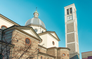 The side of church of Saint Stephen Protomartyr, with bell tower and dome, in Luigi Petazzi square, Sesto San Giovanni, municipality of Milan, Lombardy region, Italy