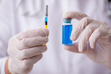 Young male doctor in vaccination concept