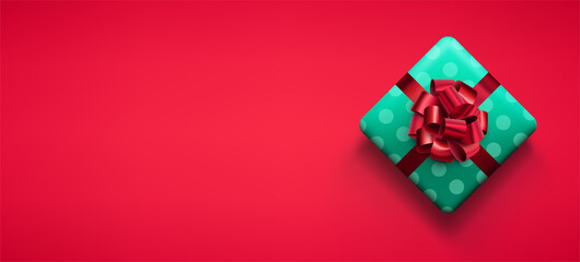 Green gift box with red bow.
