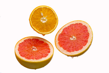 Fresh grapefruit and orange slices, isolated on a white background