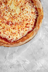 Selective focus traditional stone-baked pizza Margarita on stone table