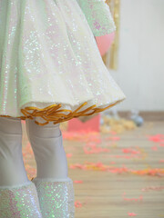 Shiny hem of the stage white skirt for the holiday. Animator costume at a children's party,...