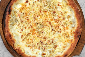 Closeup view of four cheese pizza isolated over white.