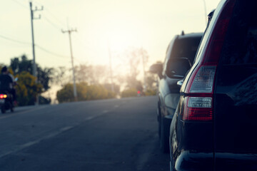 Fototapeta premium Rear view of car parking on the asphalt road for travel trip. With other car parking on the front.