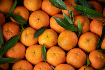 background of natural fresh tangerine with green leaves