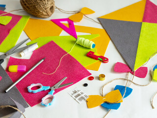 Hobby and colorful felt crafts. Workspace view. Sheets and crafts made of felt, scissors, threads...