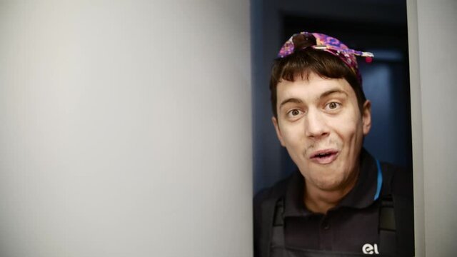 A European man comically opens the door and looks into the room. Someone's hand grabs him by the throat and pulls him out of the room.