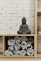 buddha on wooden shelf in yoga center